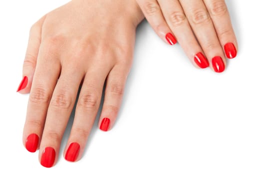 Women's hands with beautiful well-groomed fingers and red nail polish wellness beauty spa close up isolated on white background