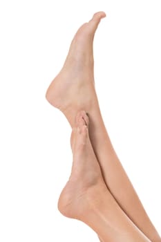 Woman with neatly groomed natural nails without varnish shows off her feet in a beauty concept on a white background