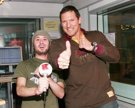 Ralf Moeller with presenter Tim Gafron live on Radio Hamburg cartoon adventure "Triff die Robinsons"",in which the 48-year-old lends his voice to a muscle-packed animation character. / Please caption: Image machine/hr"
