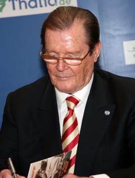 Sir Roger Moore and wife Lady Kristina at Thalia Hamburg where he presented his book My Word Is My Bond