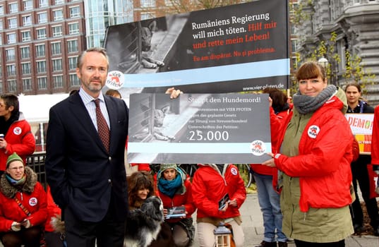 Klaus Rainer Kirchhof (Honorary Consul Romania) and Dr.Martina Stephany (Four Paws) Protest action in front of the Romanian Consulate in Hamburg together with VIER PFOTEN against the Moerderic law PL 912 passed by the Rumaenian Parliament on 22.11.2011,which legalizes the unscrupulous killing of street dogs. FOUR PAWS will hand over this protest to Romanian President Traian Basescu,as only he can now overturn the law.  Romania has passed a law that allows the mass killing of stray dogs. Studies have shown that only a comprehensive castration of stray dogs reduces the dog population.