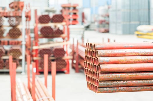 Stack of steel pipes for scaffolding in warehouse