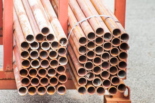 Stack of steel pipes for scaffolding in stock.