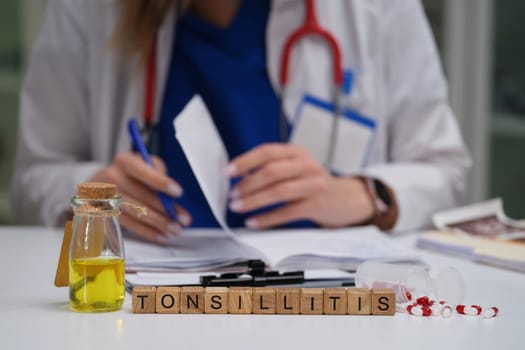 A qualified doctor meticulously studies various medical paperwork with a specific focus on tonsillitis and its remedies