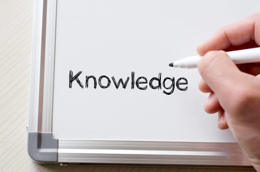Human hand writing knowledge on whiteboard