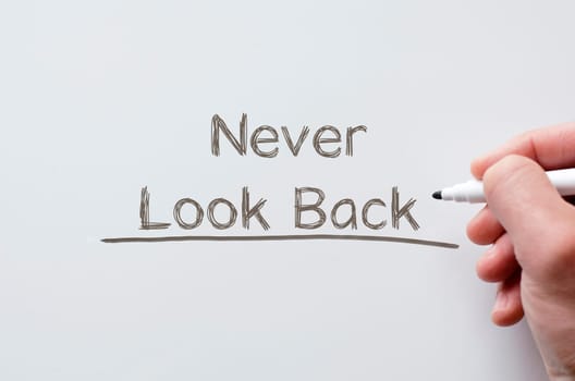 Human hand writing never look back on whiteboard