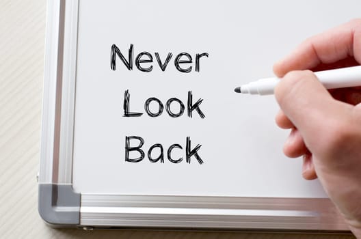 Human hand writing never look back on whiteboard
