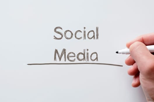 Human hand writing social media on whiteboard