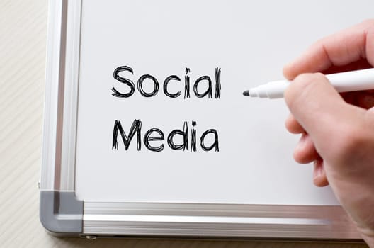 Human hand writing social media on whiteboard