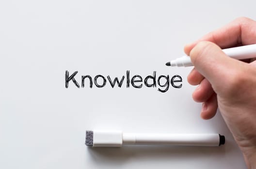Human hand writing knowledge on whiteboard