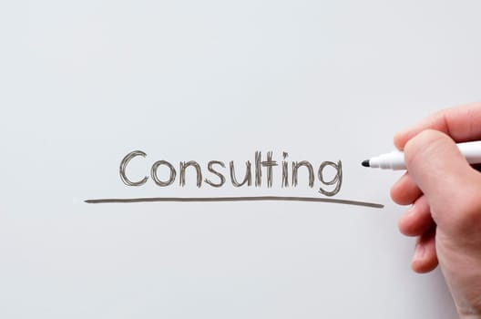 Human hand writing consulting on whiteboard