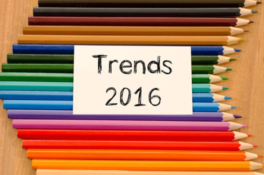 Trends 2016 text concept and colored pencil on wooden background