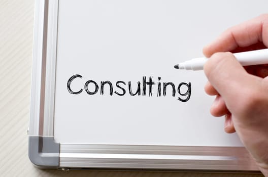 Human hand writing consulting on whiteboard