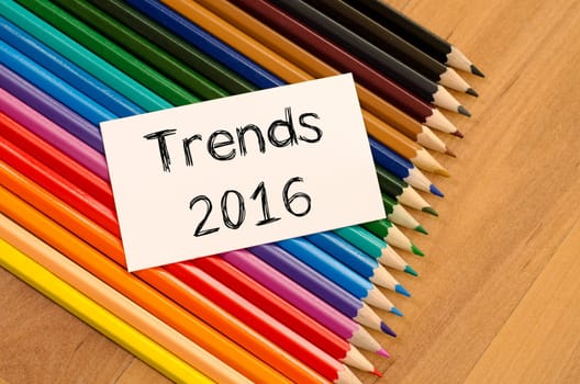Trends 2016 text concept and colored pencil on wooden background