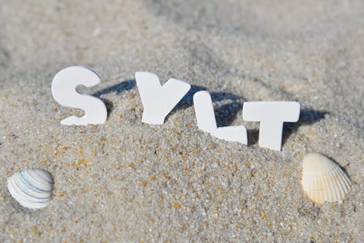 Sylt word letters in the sand