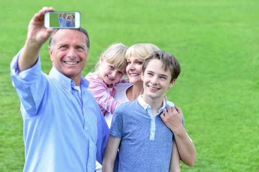 Happy family making selfie with mobile phone.