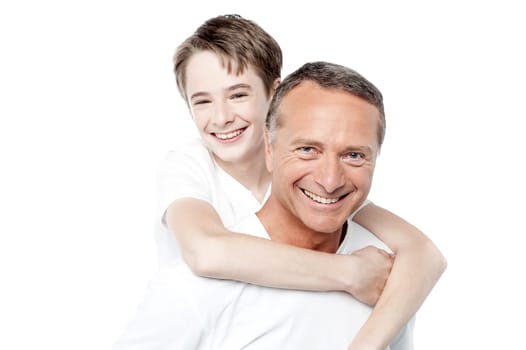Father holding young son who has his arms around his neck