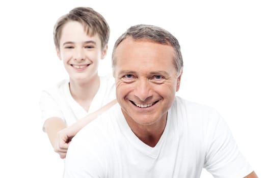 Father and son are smiling and bonding over white.