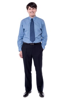 Full length image of businessman standing with his hand in pocket.