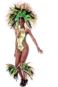 Female samba dancer wearing colorful costume over white background
