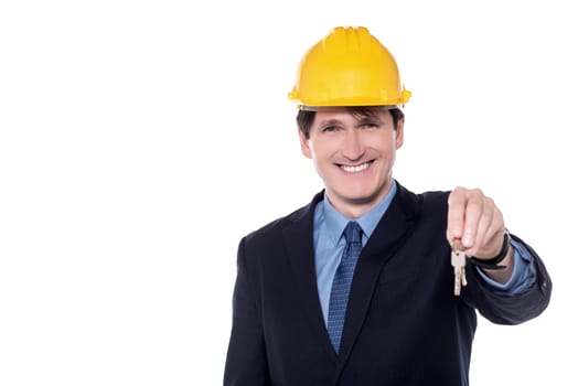 Smiling Male architect offering a new house key