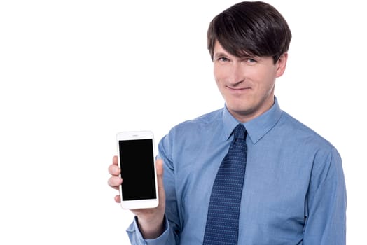 Businessman showing smartphone with blank black screen.