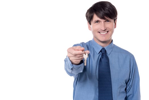 Middle aged businessman holding a house key.