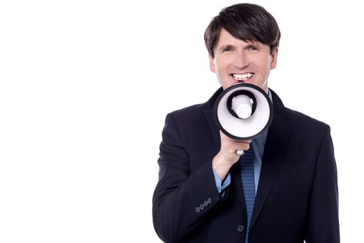 Businessman talking on a megaphone over white