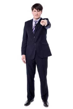 Handsome angry businessman pointing finger at you.