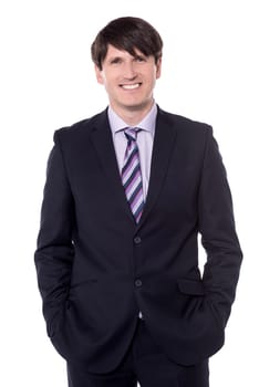 Friendly and confident businessman looking at camera and smiling.