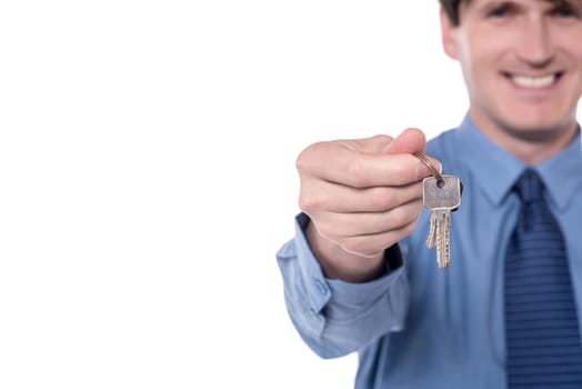 Cropped image of businessman offering house keys.