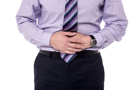 Close-up mid section of a businessman with stomach pain.