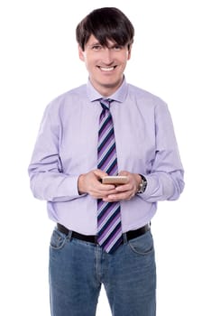Corporate executive sending message with mobile phone.