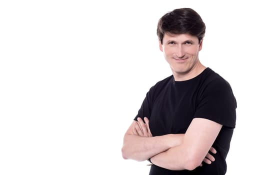 Middle aged man posing to camera with crossed arms.