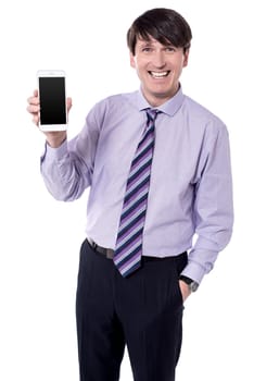 Picture of businessman showing smart phone against white background.