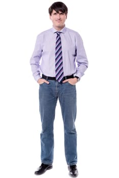 Casual picture of businessman, standing with hands in pockets.