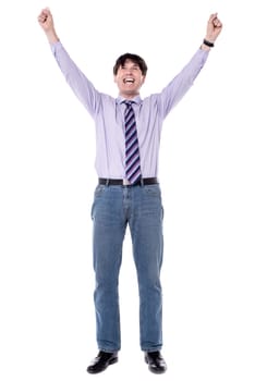 Successful business man raised his arms with clenching fists.