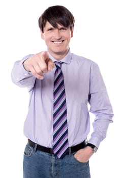 Middle aged businessman pointing finger at viewer.