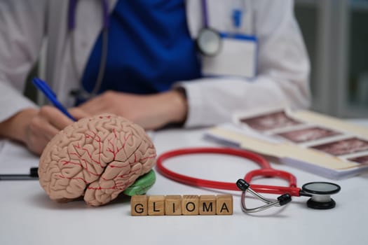 In a clinical setting, a doctor discusses glioma while utilizing a brain model and various medical tools