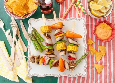 Colorful grilled skewers with fresh vegetables and bratwurst