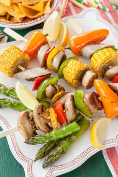 Colorful grilled skewers with fresh vegetables and bratwurst