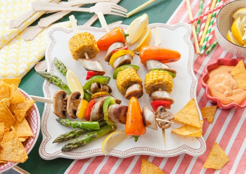 Colorful grilled skewers with fresh vegetables and bratwurst