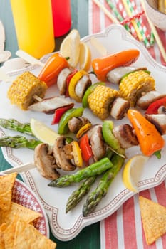 Colorful grilled skewers with fresh vegetables and bratwurst