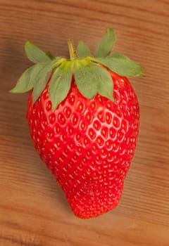 Ripe strawberrie over wooden table background