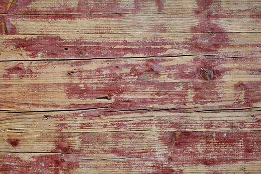 Old grunge weathered rustic wooden table background texture with cracked boards and weatherworn paint, full frame view