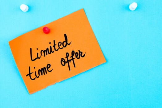 Limited Time Offer written on orange paper note pinned on cork board with white thumbtack, copy space available