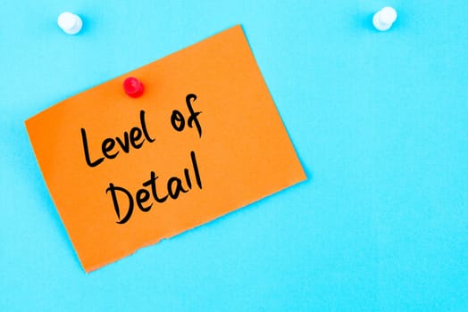 Level Of Detail written on orange paper note pinned on cork board with white thumbtack, copy space available