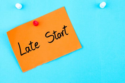 Late Start written on orange paper note pinned on cork board with white thumbtack, copy space available