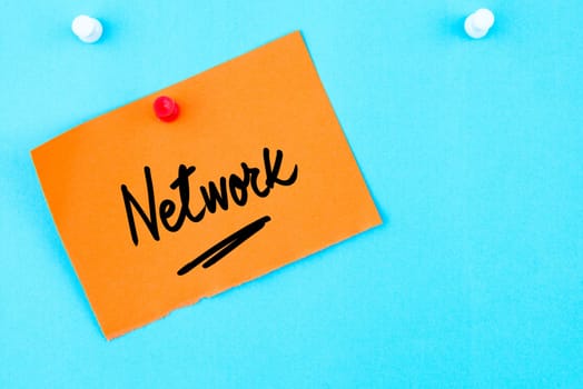 Network written on orange paper note pinned on cork board with white thumbtack, copy space available