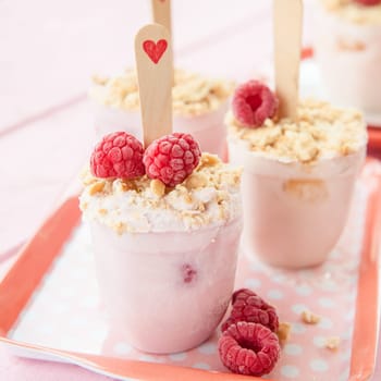 Homemade popsicles with raspberries and biscuits